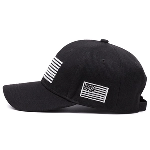 Detail of white American flag embroidery on a premium black cotton baseball cap