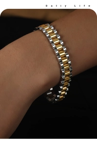 Macro shot of two-tone gold and silver link bracelet with watch strap design and polished finish