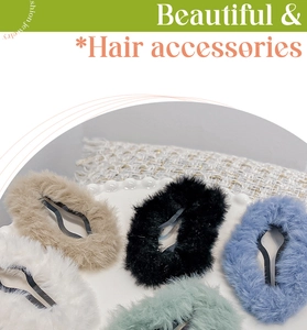 Close-up of plush cloud hair clips in white, beige, black, blue, and green colors