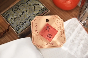 Macro shot of acrylic fridge magnet with gold foil and Chinese peace calligraphy