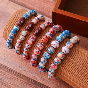 Detail shot of sports-themed beaded bracelets with football and basketball beads