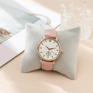 Detail of pink leather watch strap with rose gold case and small seconds sub-dial on white face
