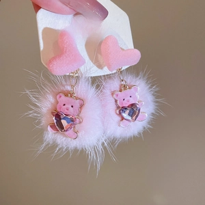 Close-up of pink fluffy ball earrings with cute bear pendant and S925 silver needle