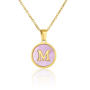 Detail of a gold necklace featuring a round pink shell pendant with the letter M