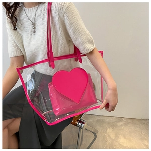 Detail of pink transparent PVC tote bag featuring a matching heart inner pouch and trim