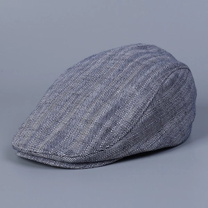 Close-up of blue and white herringbone fabric detail on a retro British flat cap