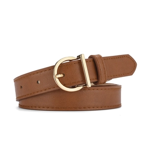 Detail view of a vintage brown leather belt with a polished gold D-ring metal buckle