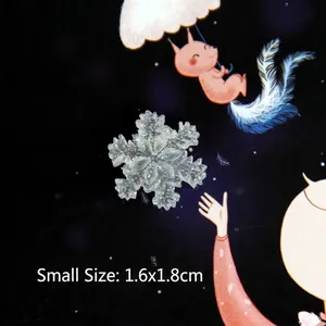 Macro detail of small 1.6x1.8cm translucent glitter resin snowflake for DIY crafts