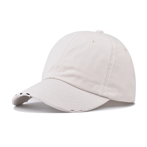 Detail view of washed cotton baseball cap showing distressed brim and white stitching