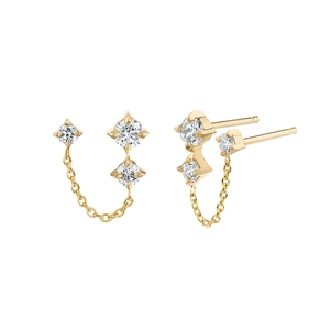 Macro detail of gold chain earrings with three sparkling star-shaped cubic zirconia studs