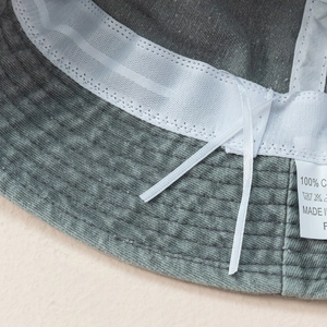 Detail of washed grey bucket hat interior with mesh sweatband and adjustable drawstring