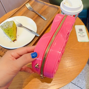 Detail view of pink heart-shaped bag with brick texture and durable metal zipper