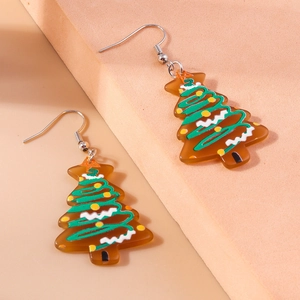 Detail view of acrylic Christmas tree earrings with green swirls on a beige background