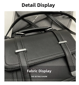 Detail showing high-quality black litchi grain leather texture and silver hardware of bag