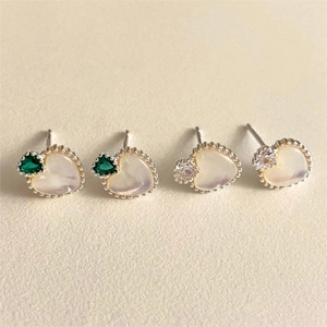 Detail of 925 sterling silver heart earrings with green zircon and white shell inlay