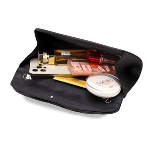 Internal view of black fabric clutch showing space for perfume, phone, and makeup
