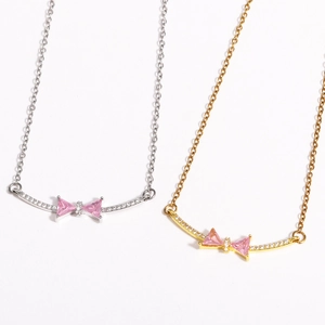 Elegant gold and silver bow necklaces with pink zircon stones on a clean white background