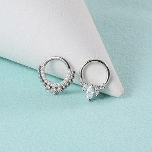 Macro shot of silver stainless steel septum rings with clear cubic zirconia stones