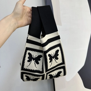 Detail of knit handbag featuring vintage butterfly pattern and thick woven texture