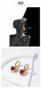 Detail shot of heart earrings showing size dimensions 2.3cm height and gold finish