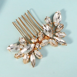 Detail of bridal hair comb with gold metal finish and marquise rhinestones in petal design