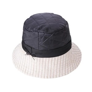 Detail of quilted nylon crown and corduroy brim with a bow on this winter bucket hat