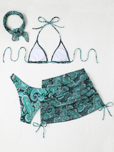 Flat lay of 4-piece paisley print bikini set with sarong and matching hair scrunchie