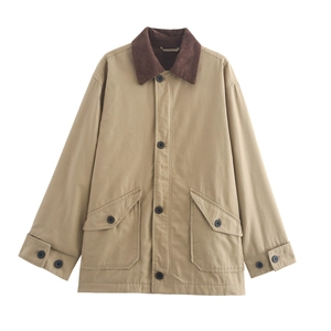 Close-up of contrast corduroy collar and buttoned pockets on khaki utility jacket
