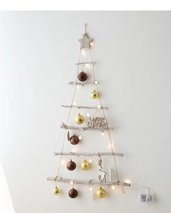 Close-up of wall-mounted wooden Christmas tree with LED lights and festive ornaments