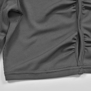 Close-up of grey ribbed knit fabric texture with adjustable drawstring detail