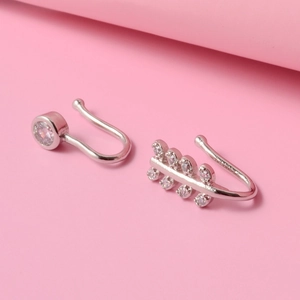 Silver leaf and round zircon non-piercing ear cuffs on soft pink background