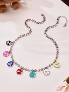 Detailed view of silver necklace with colorful enamel sun and moon space pendants