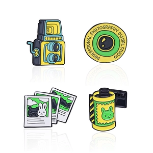 Vintage camera and film enamel pin set with retro photography studio logo design