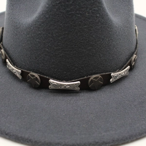 Detail of dark gray felt fedora featuring leather band with star and bone metal studs