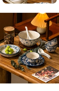 Detailed close-up of blue and white ceramic tableware set on a rustic wooden table