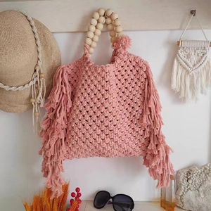 Pink bohemian woven macrame crossbody mini bag with wood bead handle and side fringes