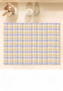 Absorbent kitchen mat with blue and yellow checkered pattern showing instant water absorption