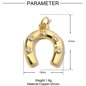 Detailed view of golden horseshoe pendant with cubic zirconia, size 21mm by 15mm