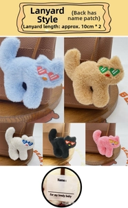 Detail of plush cat charms with heart-shaped glasses and writeable name tags