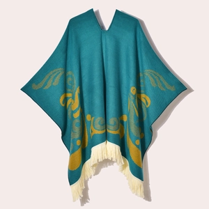 Detail of teal and yellow western poncho featuring cream tassel fringe and knit texture