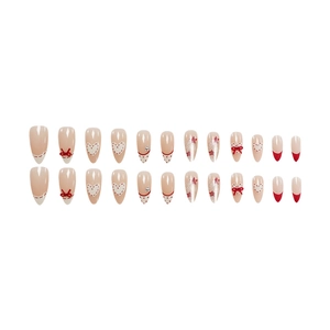 Almond press-on nails with red bows, heart patterns, and silver glitter on nude base