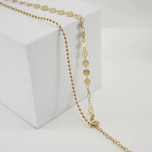 Double-layered golden stainless steel anklet with beads and circular disks on display