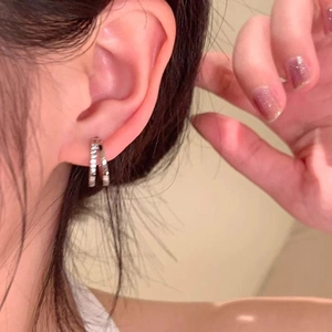 Minimalist silver double hoop earrings for women shown worn in a lifestyle close-up shot