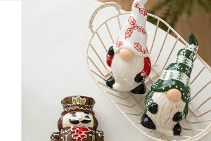 Detailed macro view of ceramic Christmas gnomes and nutcracker set in a decorative basket
