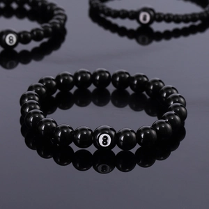 Fashionable Billiard Lucky Black 8 obsidian-style beaded bracelets on reflective surface