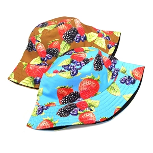 Reversible strawberry and berry print bucket hat for women in sky blue and tan tones