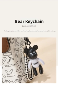 Detail of white leather handbag with bear charm and black woven strap