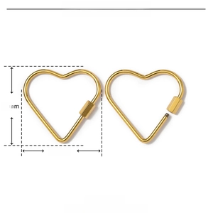 Macro view of gold heart-shaped stainless steel carabiner with dimension specifications