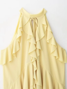 Macro detail of layered ruffles and halter neck tie on vibrant yellow chiffon top