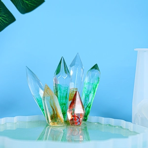 Detailed view of six colorful hexagonal crystal resin pillars in a decorative tray
